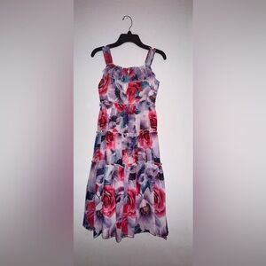 Casual floral dress with gold accessory.